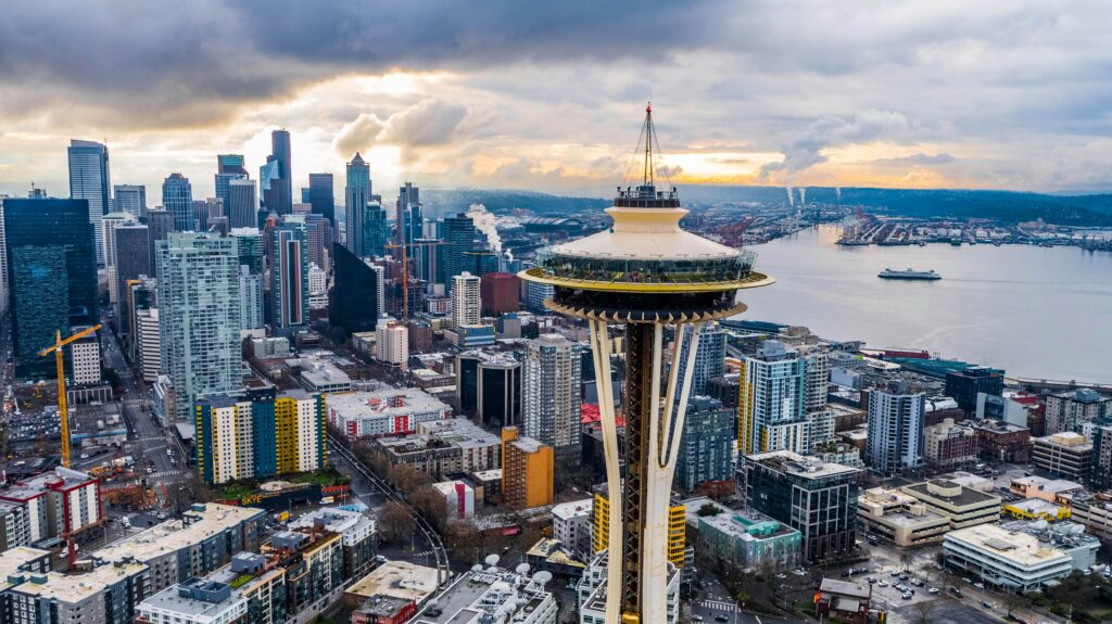 Home Stunning aerial shot of Seattle's skyline featuring the iconic Space Needle at sunset.